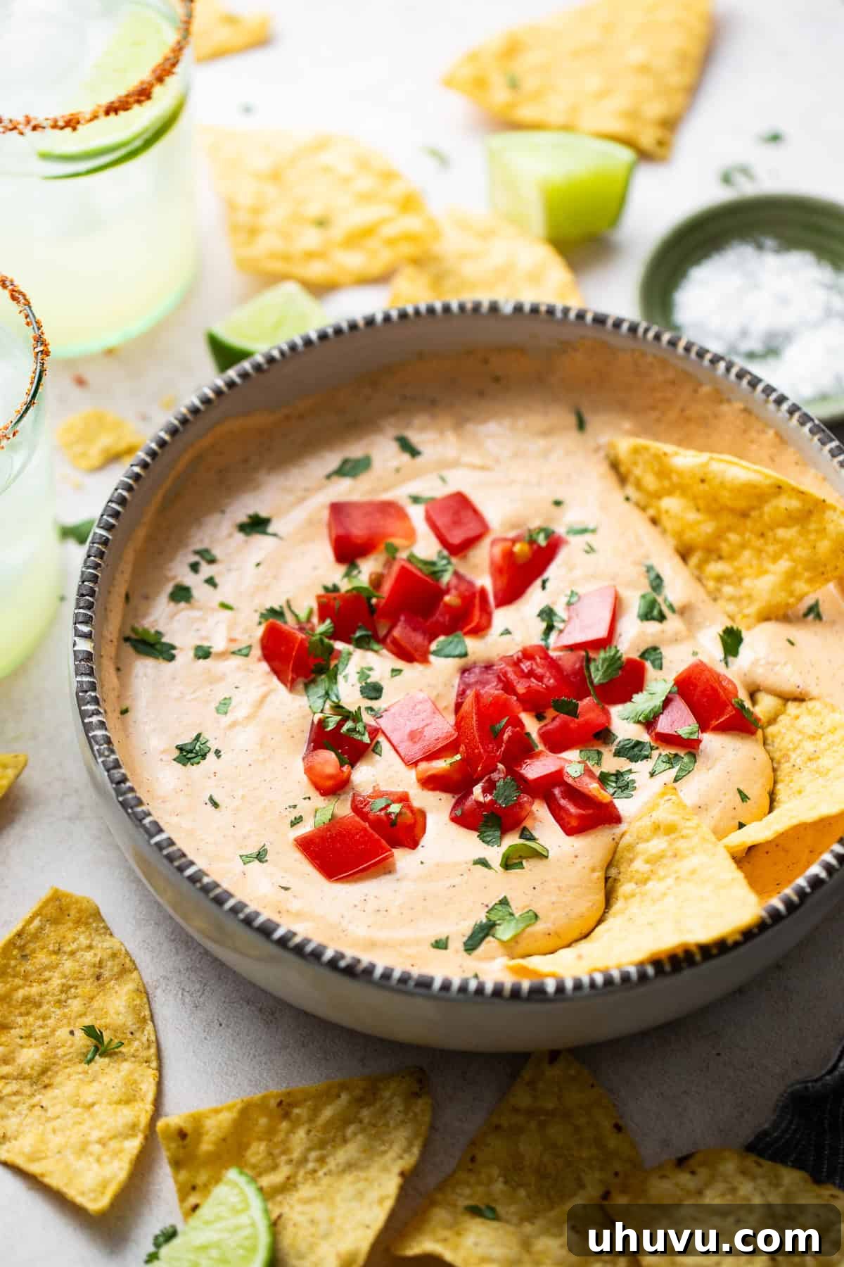 Creamy Cottage Queso 9 Cottage cheese queso served in a bowl with a side of homemade tortilla chips and fresh cilantro garnish.