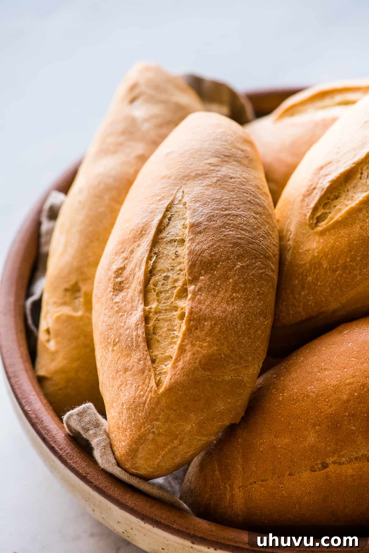 Mexican Bolillo Rolls 13 Mexican bolillo bread in a large serving bowl ready to eat.