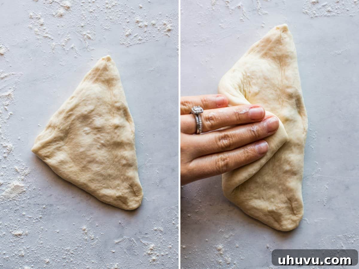 Mexican Bolillo Rolls 8 Dough being flattened with fingers to be shaped into bolillo roll.