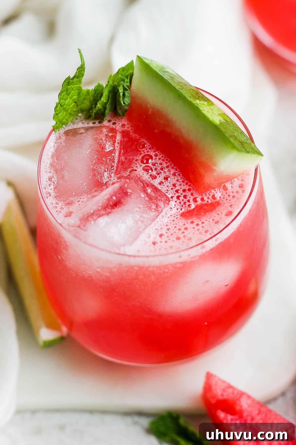 Cool Watermelon Refreshment 7 A glass of iced watermelon agua fresca (also known as agua de sandia) with a garnish of mint and fresh watermelon.