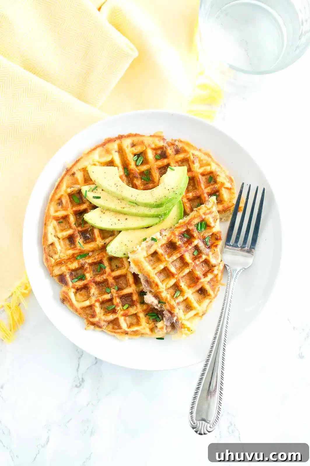Stacked crispy Sausage and Potato Waffles on a white plate, ready to be served
