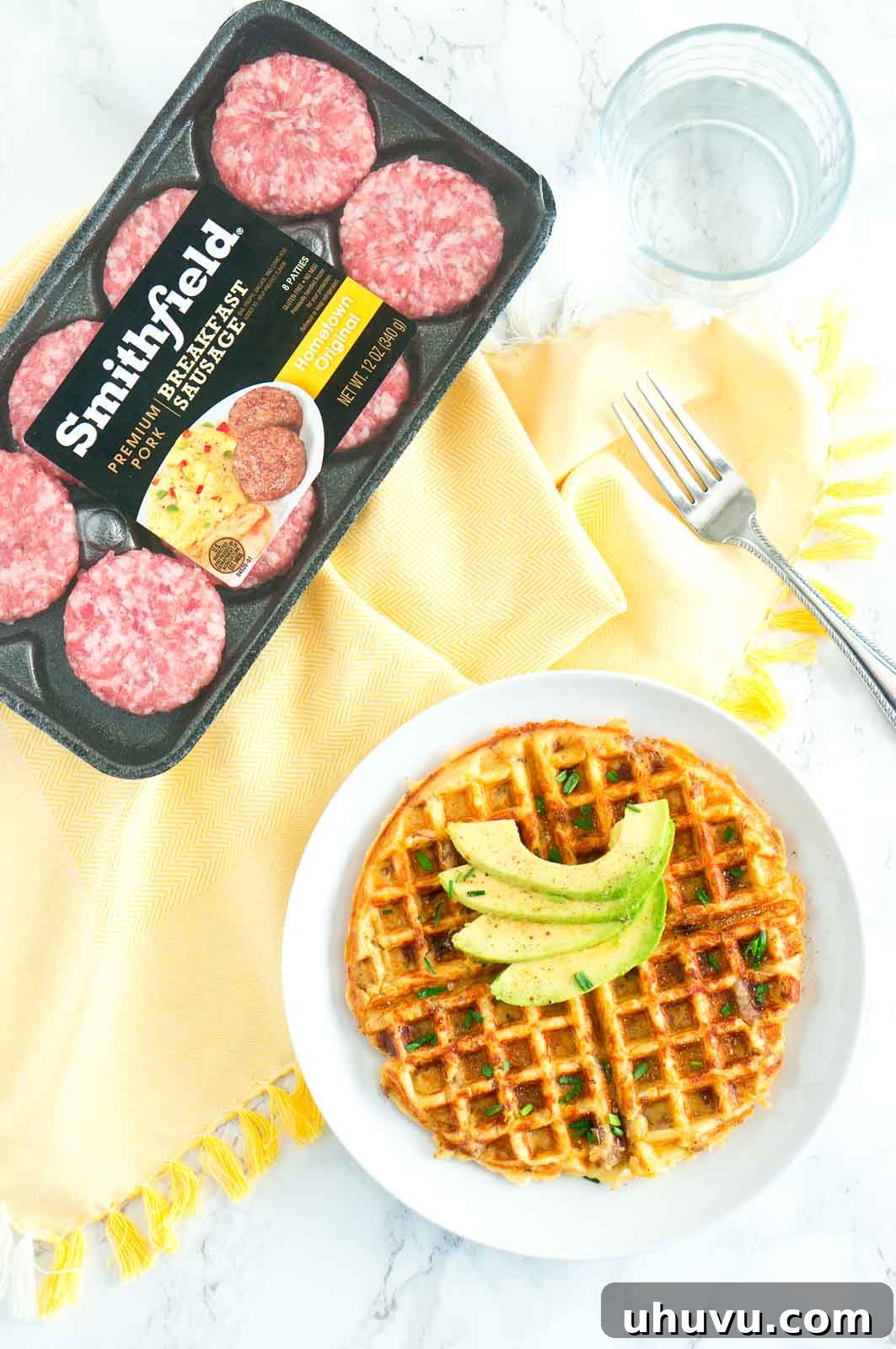 Grilled Sausage and Crispy Potato Waffles 5 Close up of a single Sausage and Potato Waffle on a plate garnished with chives