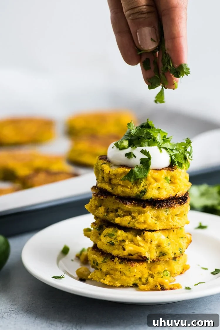 A close-up of a cooked Jalapeno Corn Cake, displaying its crispy texture and the visible pieces of corn and jalapeno.