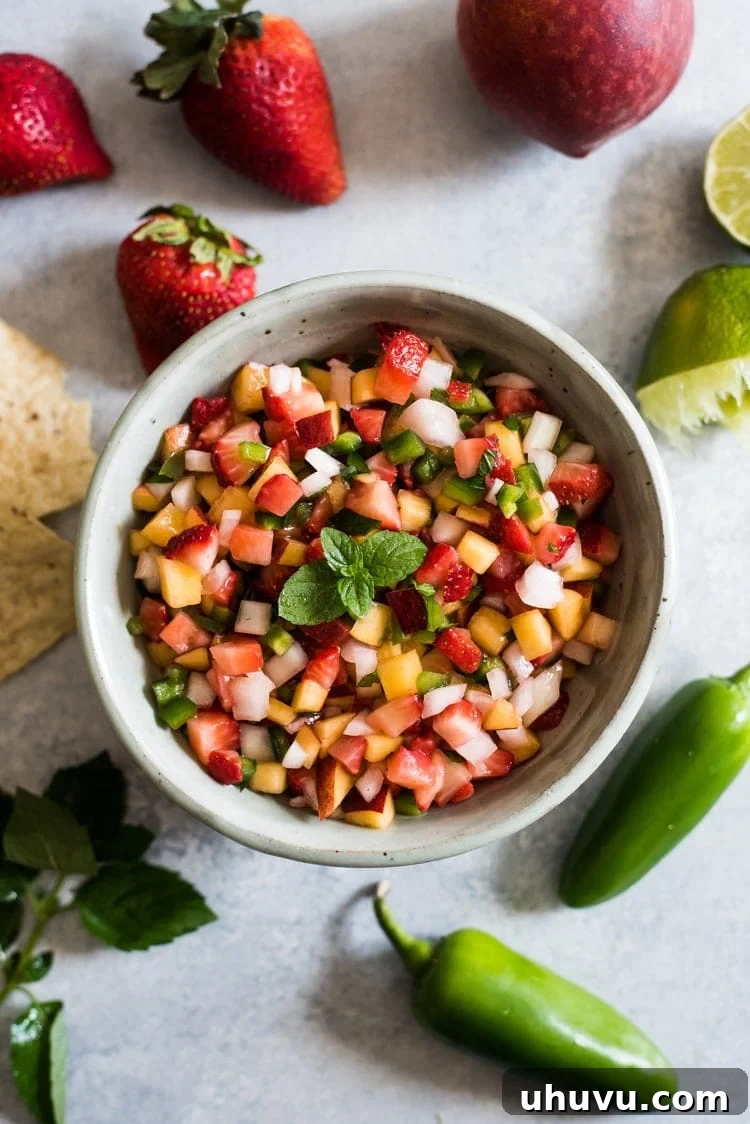 Freshly prepared Peach Strawberry Salsa in a decorative bowl, ready to be enjoyed with tortilla chips.