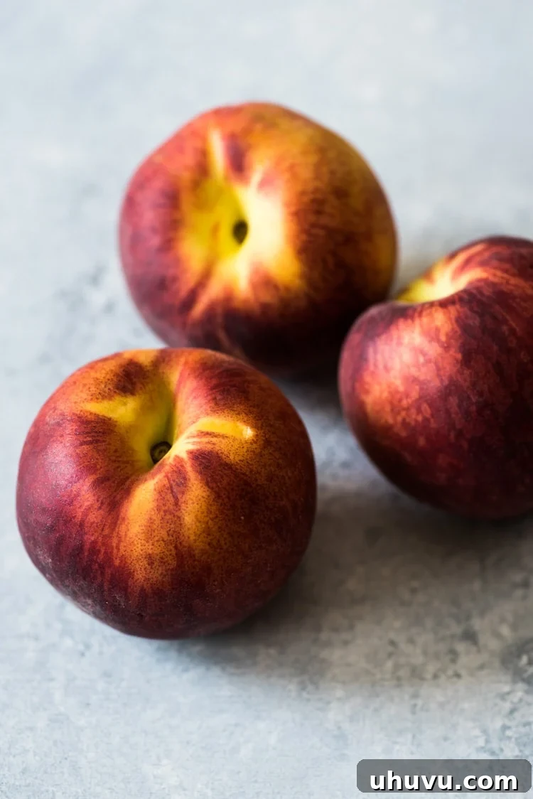 A close-up view of the vibrant Peach Strawberry Salsa, highlighting the finely diced strawberries, peaches, and green herbs.