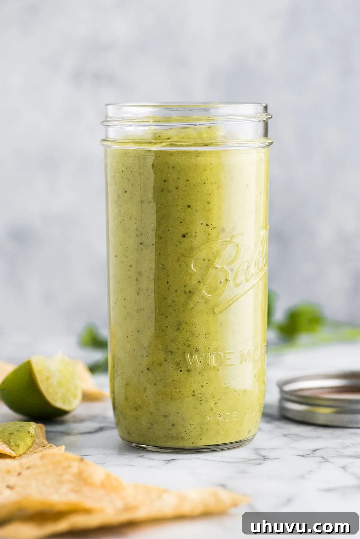 Creamy Verde Salsa 2 Guacamole salsa in jar, showcasing its vibrant green color and smooth texture.