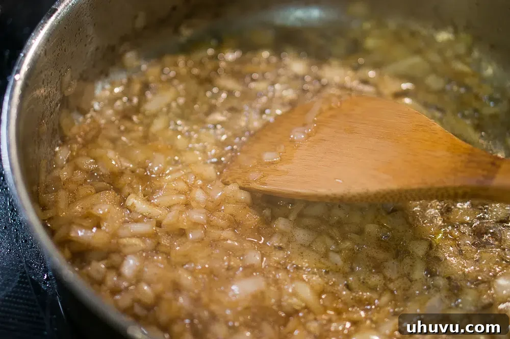 Sautéing onions in rich bacon fat for German Pan Fried Potatoes