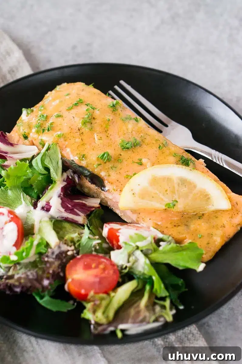 maple glazed salmon on a plate with a green salad