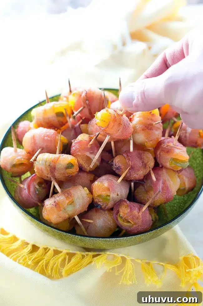 Fiery Apricot-Bacon Bundles 3 Close-up of freshly baked bacon-wrapped apricots with jalapeño, ready to be served as an appetizer.