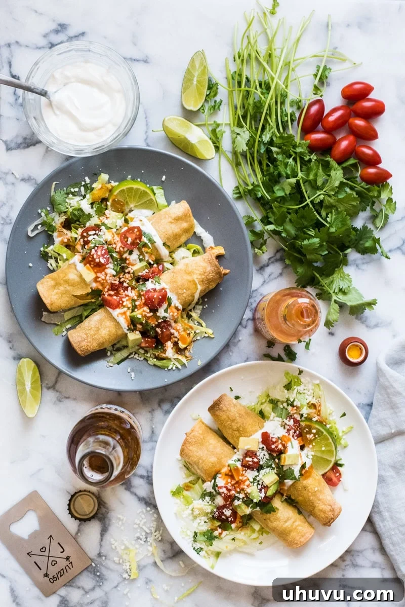 Baked chicken taquitos generously topped with sour cream, cilantro, and avocado
