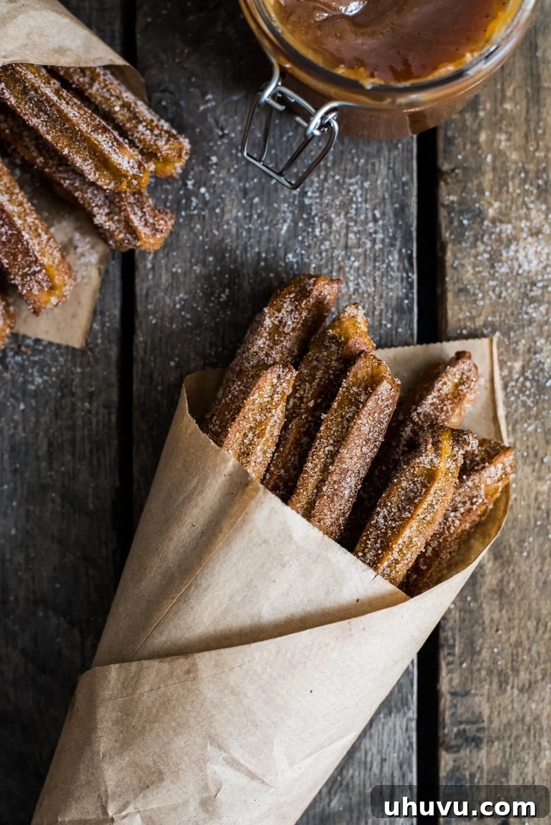 Close-up of Baked Pumpkin Churros with a rich dipping sauce, highlighting the crunchy exterior and soft interior. A perfect autumn and winter dessert.