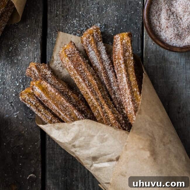 Baked Pumpkin Churros covered in cinnamon sugar are the perfect fall and winter dessert. They're baked, not fried, which means you can eat more of them!
