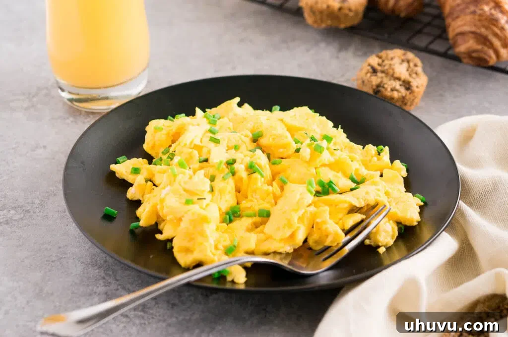 scrambled eggs recipe with chives on a plate