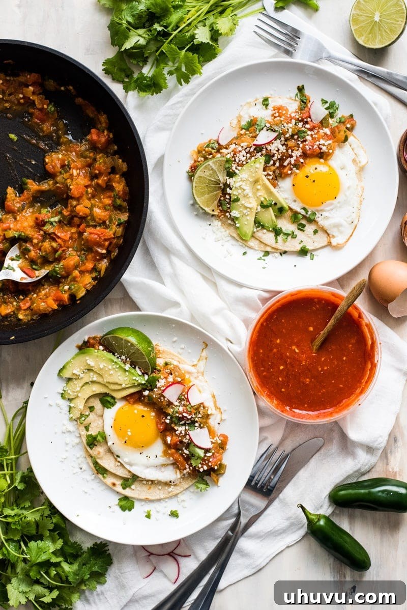 Sunrise Ranch Eggs 3 Huevos rancheros on a plate with some spicy salsa on the side and sliced avocado on top.