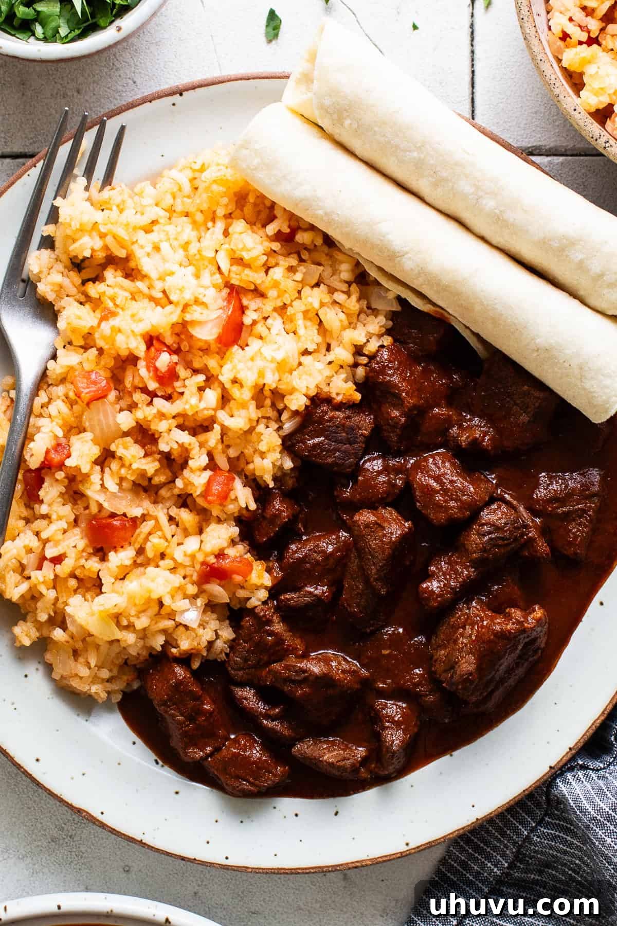Chile colorado served the traditional and authentic way with Mexican rice on the side.