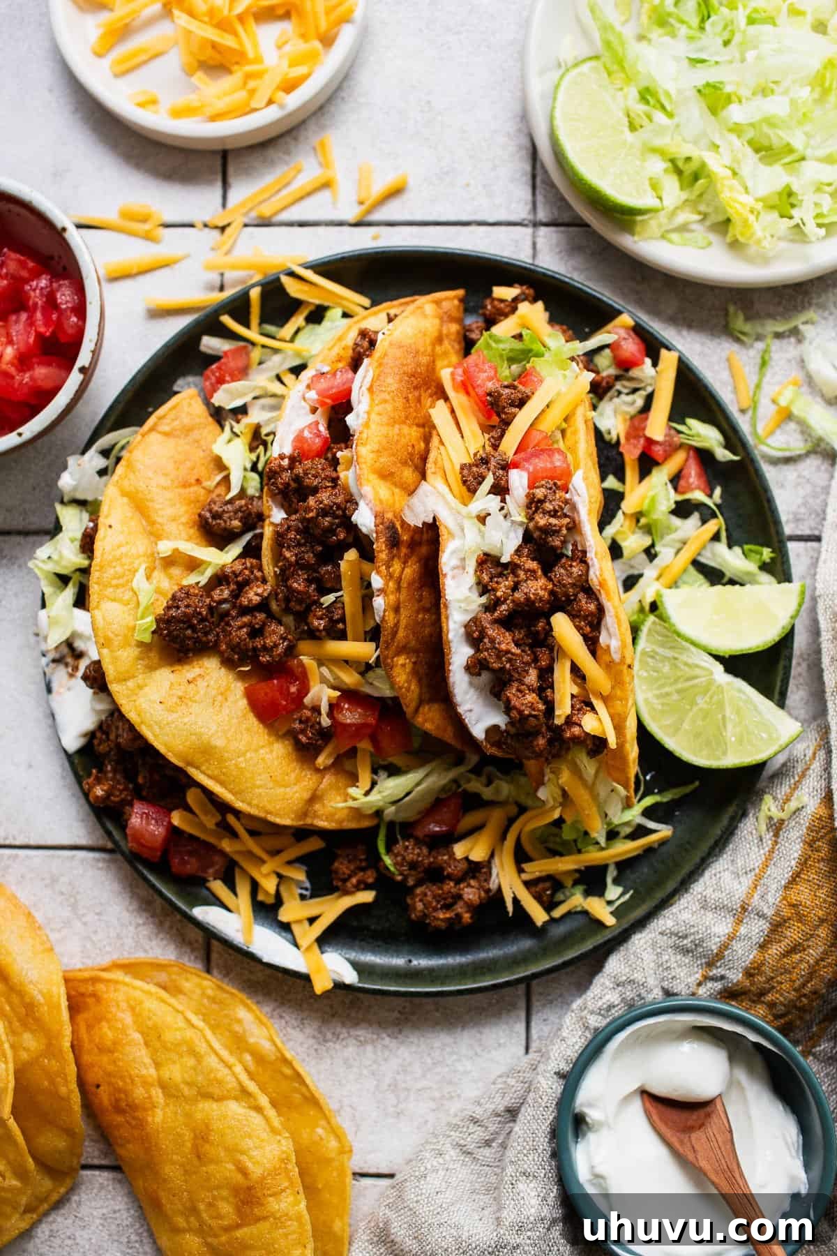 Ultimate Ground Beef Tacos 6 Homemade hard shell ground beef tacos served with lettuce, tomatoes, and cheese.