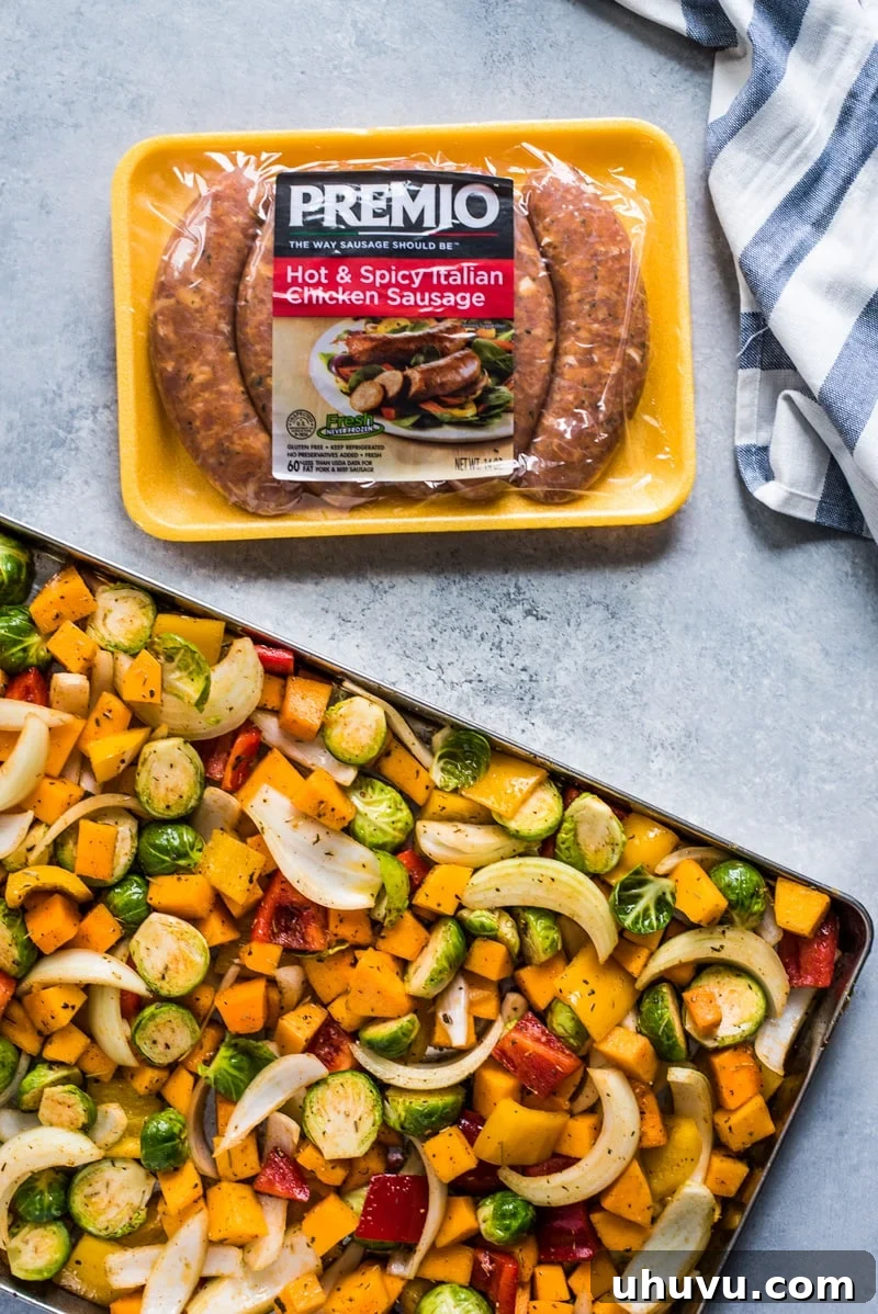 Colorful sheet pan dinner with sausage and roasted vegetables.