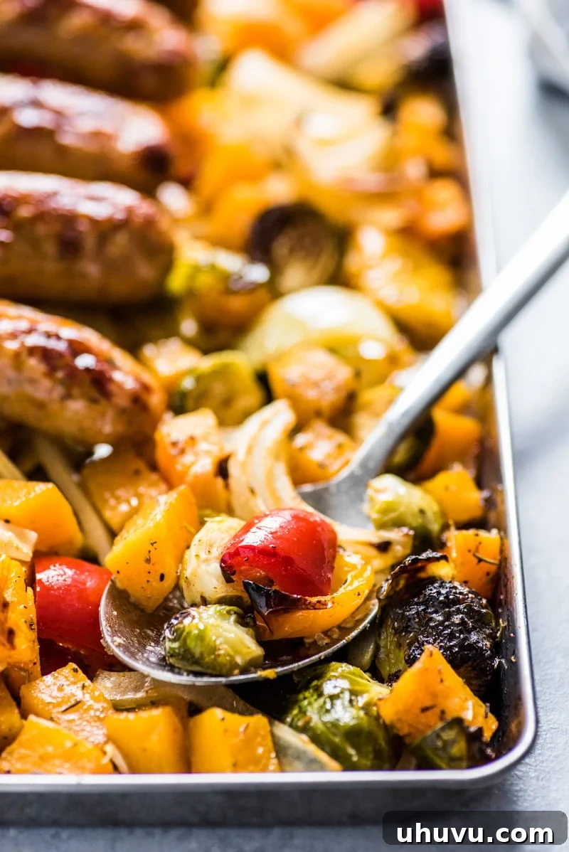 One-Pan Wholesome Sausage and Roasted Veggies 7 Sheet pan filled with raw Premio chicken sausage and seasoned vegetables, ready for the oven.