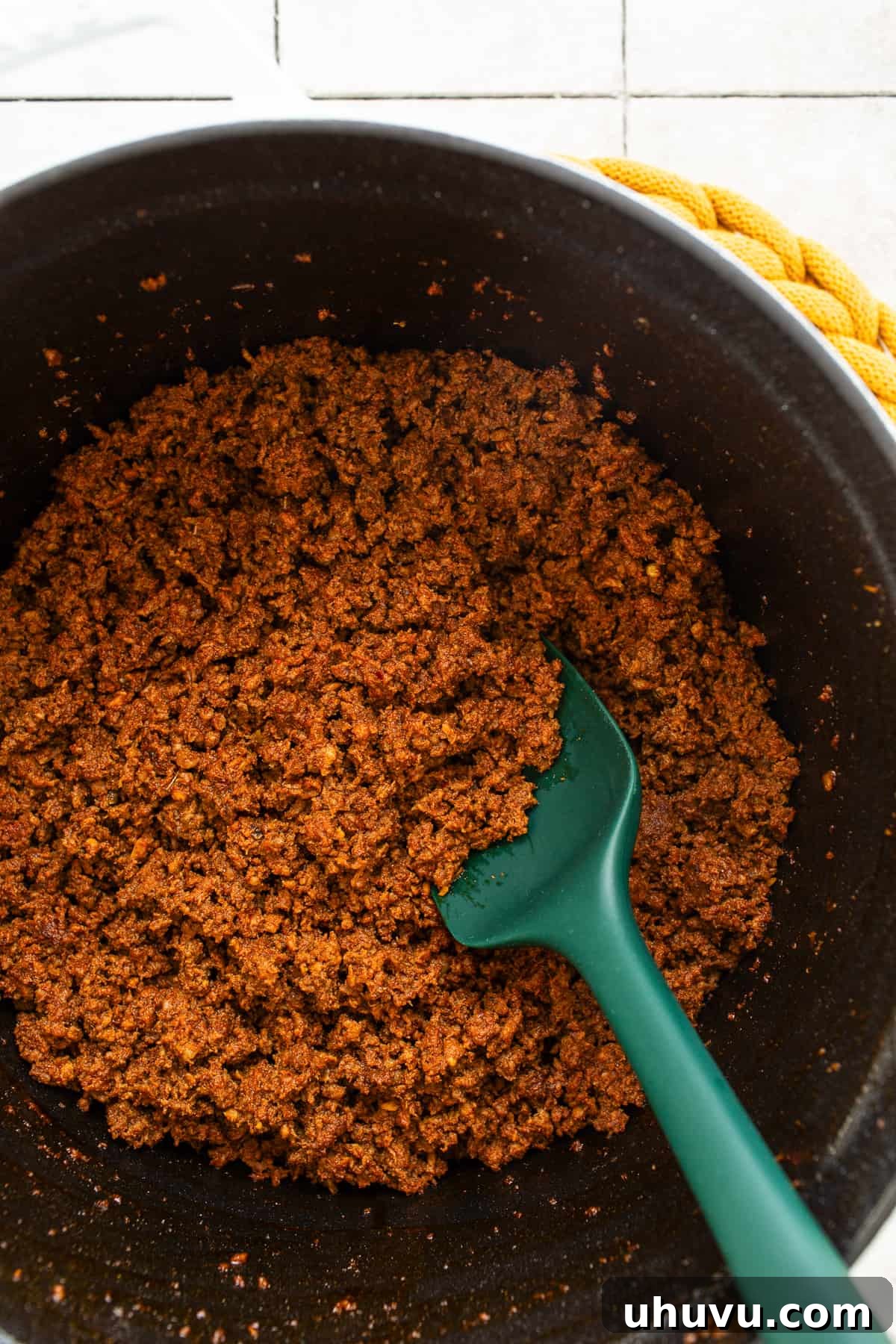 Chorizo Kick Chili 4 Sizzling ground beef and Mexican chorizo browning in a large Dutch oven, releasing rich aromas and creating a savory base for the chili.