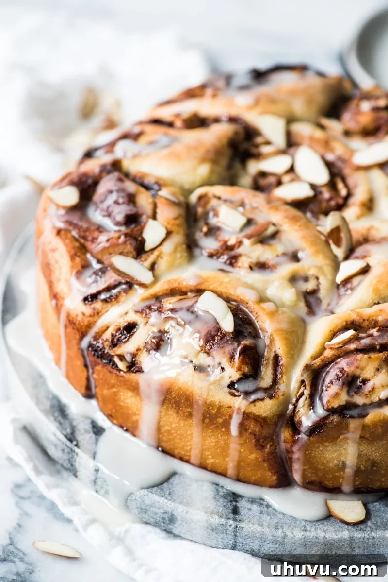 Spiced Mexican Chocolate Cinnamon Buns 2 Freshly baked Mexican Chocolate Cinnamon Rolls, glistening with a sugar glaze, ready for breakfast or brunch.