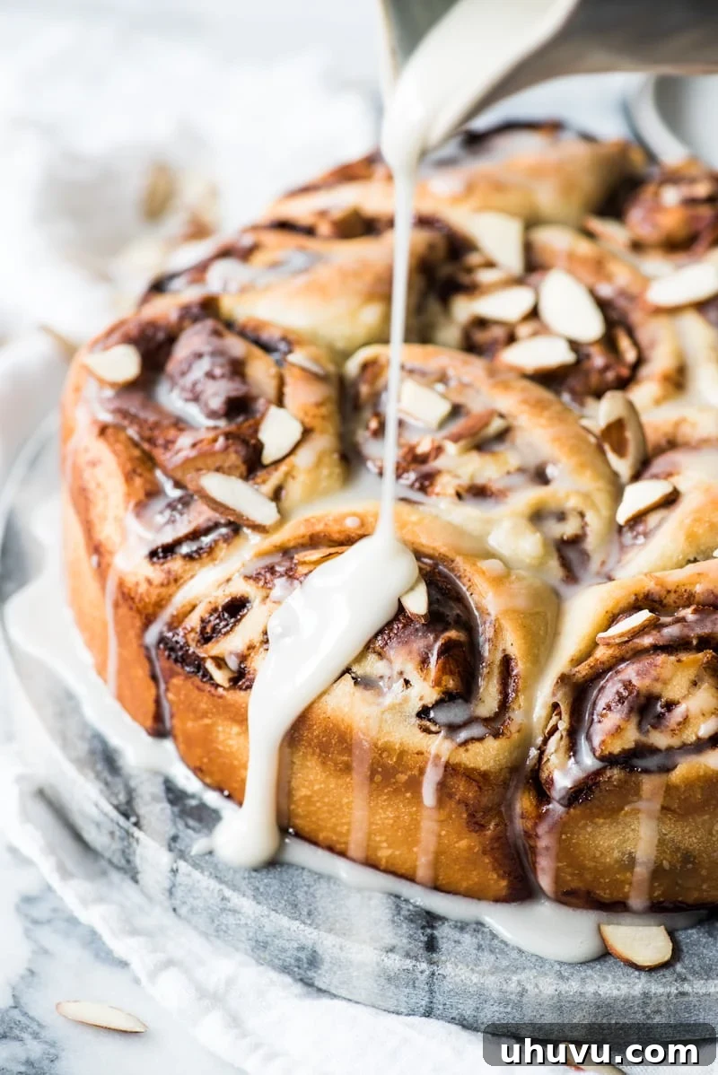 Spiced Mexican Chocolate Cinnamon Buns 4 A tray of warm Mexican Chocolate Cinnamon Rolls, fresh from the oven, drizzled with sweet icing.
