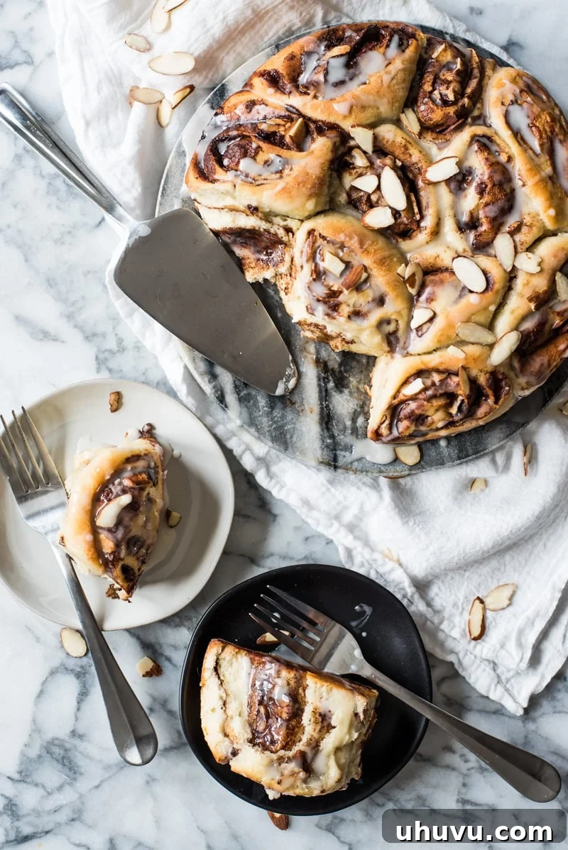 Spiced Mexican Chocolate Cinnamon Buns 6 A stack of two freshly baked Mexican Chocolate Cinnamon Rolls, showing the soft interior and the melted glaze.