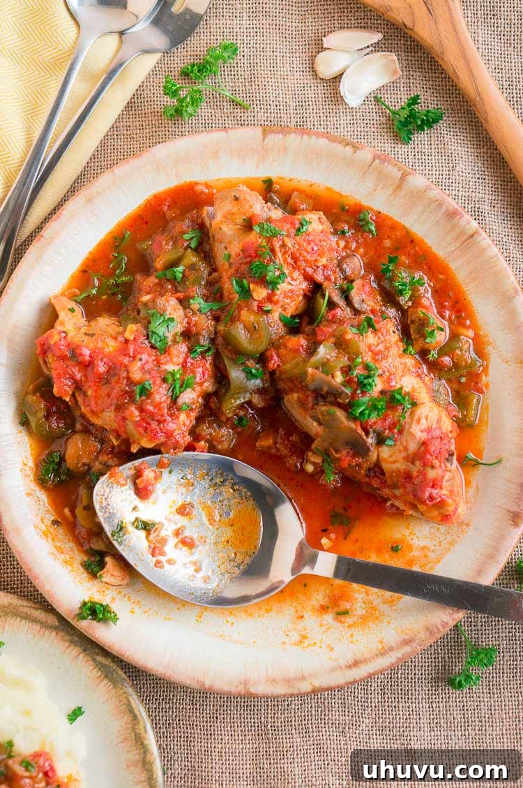 A bowl of Instant Pot Chicken Cacciatore with fresh herbs