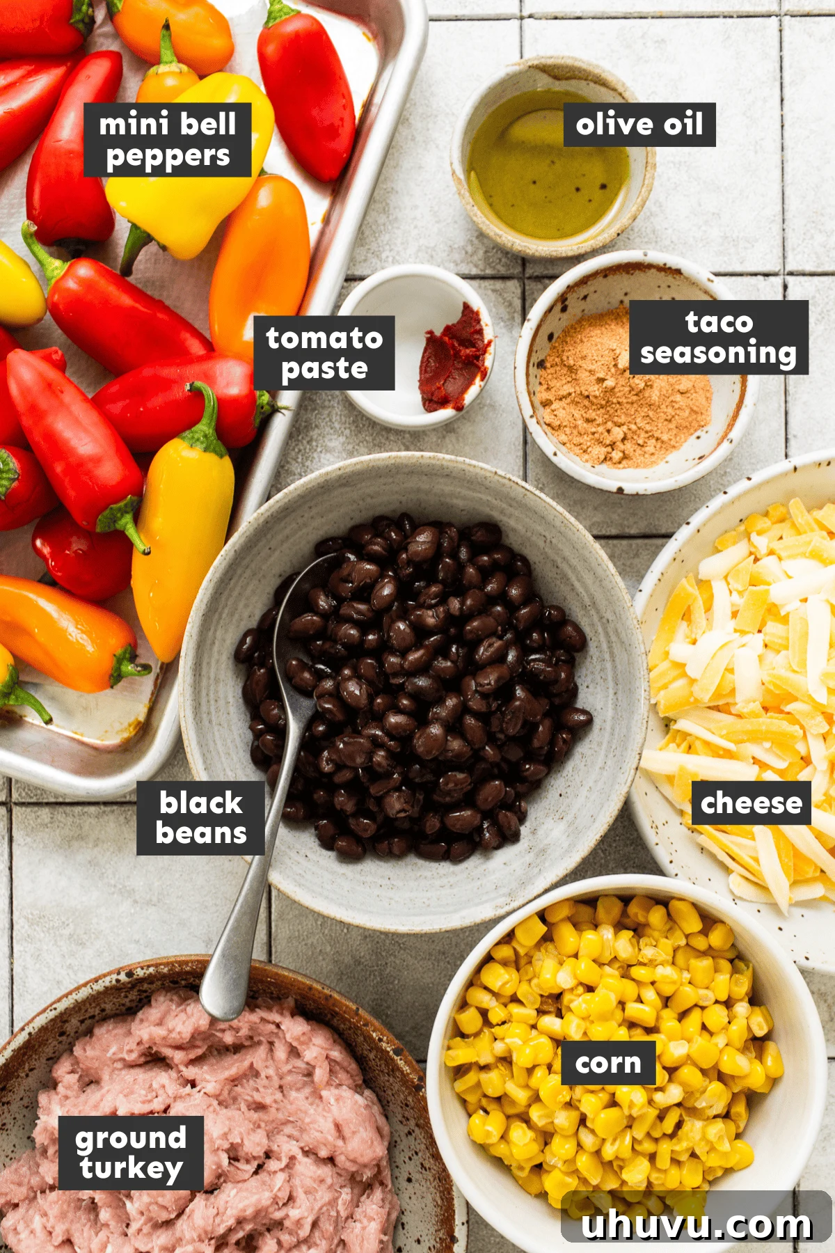 Rainbow Pepper Nachos 4 All the fresh ingredients for bell pepper nachos neatly laid out on a table, including colorful bell peppers, ground turkey, black beans, corn, and cheese.