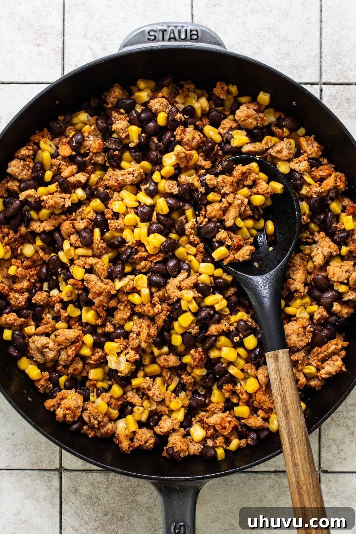 Rainbow Pepper Nachos 5 A large skillet filled with a savory ground turkey, black bean, and corn mixture, perfectly cooked and ready for the bell peppers.