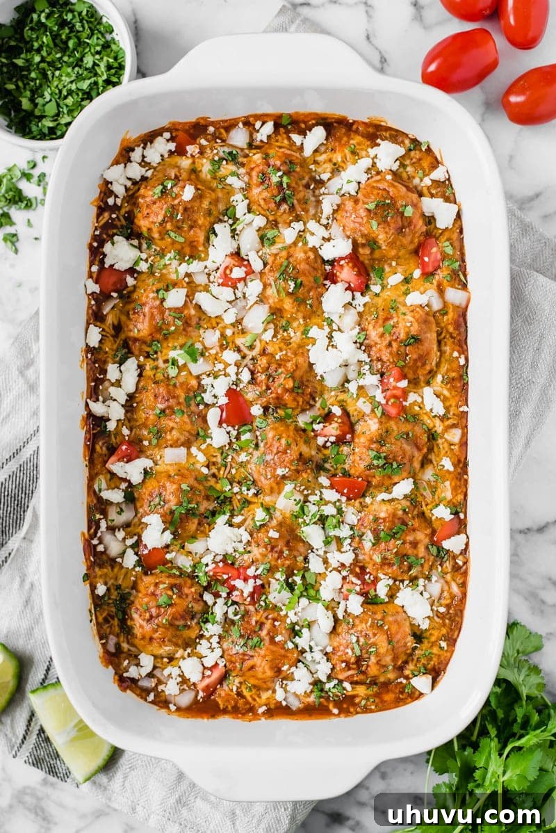 Flavorful Gluten Free Enchilada Chicken Meatballs 2 Delicious gluten-free chicken meatballs smothered in red enchilada sauce, garnished with fresh cilantro and Cotija cheese.