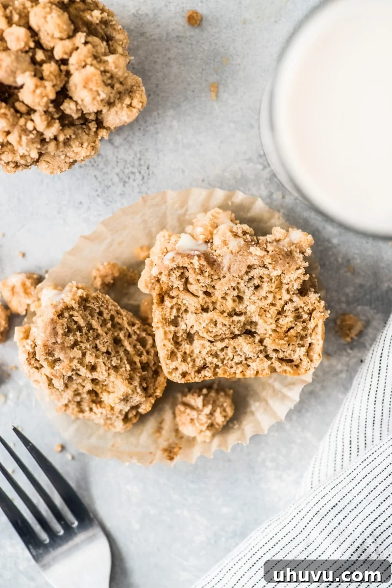 Freshly baked cinnamon coffee cake muffins cooling on a rack