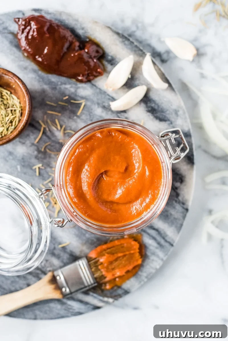 Chipotle Kick Zero Sugar BBQ Sauce 5 Serving homemade sugar-free BBQ sauce in a rustic jar, ready to be enjoyed with grilled dishes.