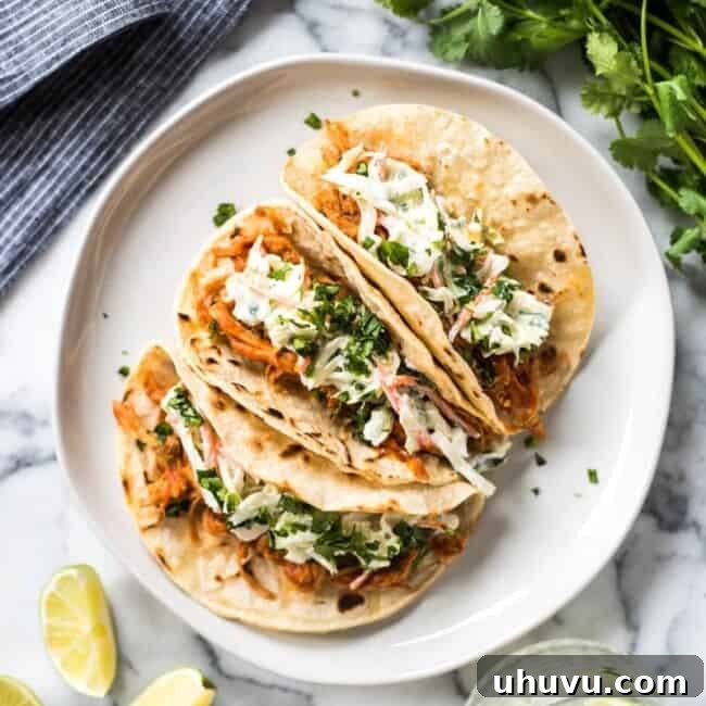 Flavorful Slow Cooker BBQ Pulled Pork Tacos with a zesty cilantro lime coleslaw, perfect for healthy weeknight meals.