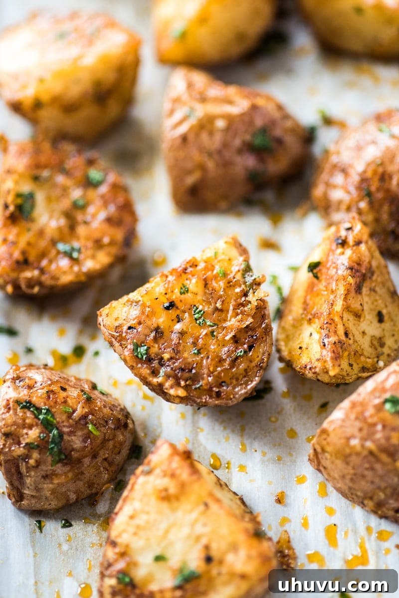 Spicy Mexican Spuds 3 Golden-brown, crispy Mexican roasted potatoes arranged on parchment paper.