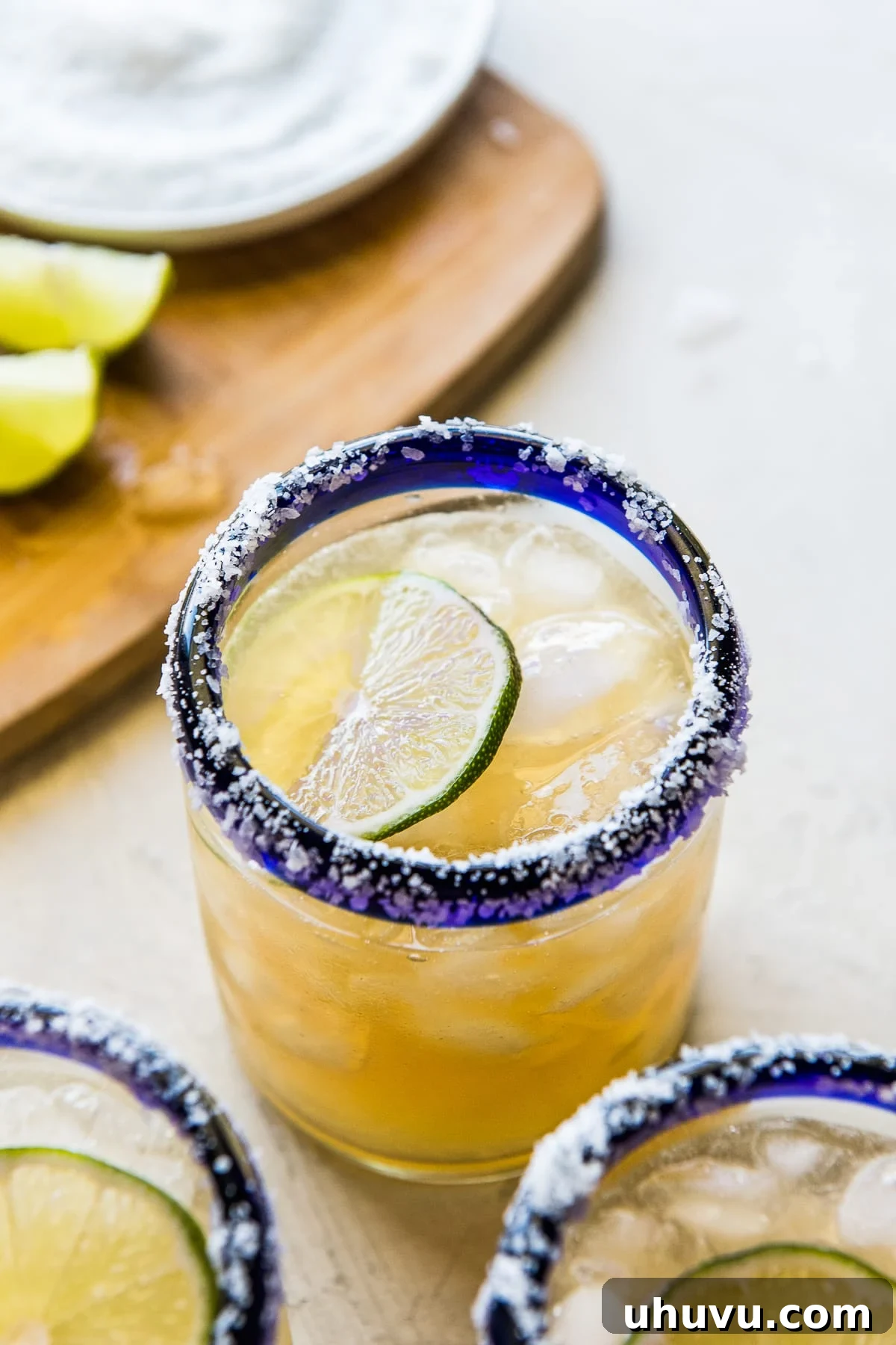 Crafting the Perfect Margarita 5 The best classic margarita in an iced glass garnished with a slice of lime, inviting a refreshing sip.