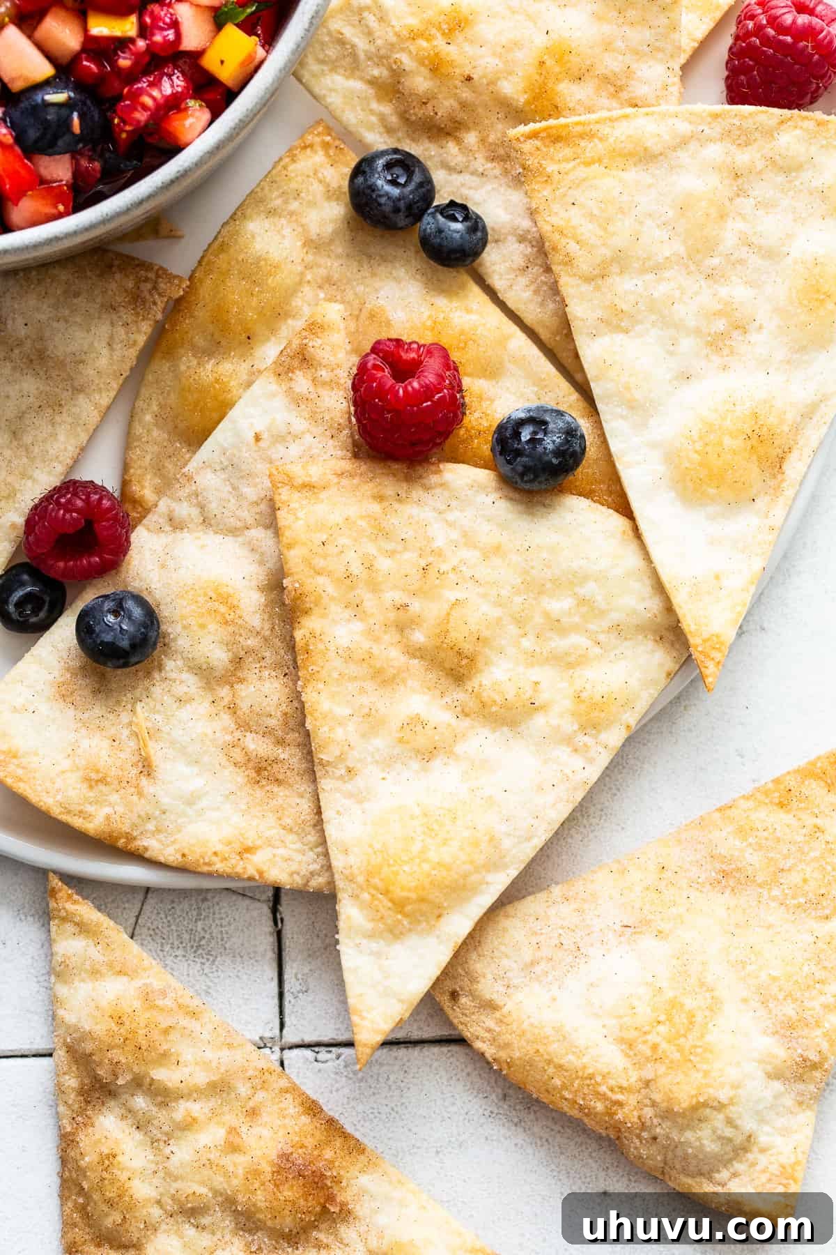 Vibrant Fruit Salsa 6 Baked crispy cinnamon chips made from flour tortillas on a plate.