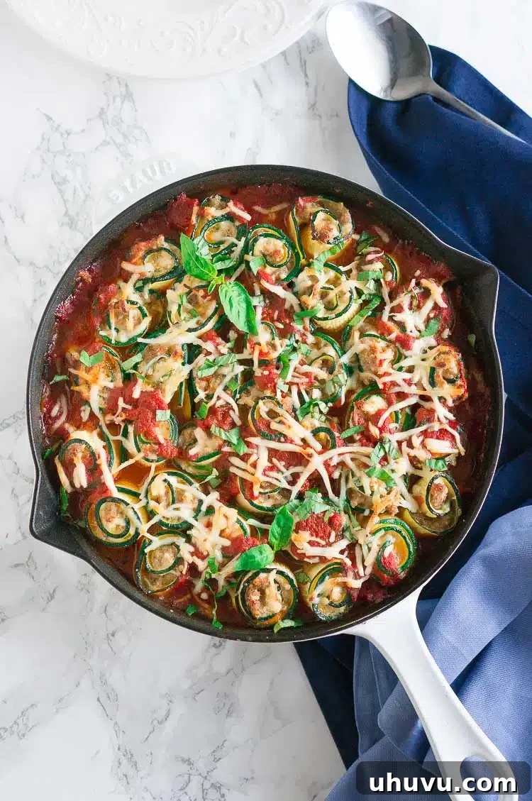 Plated Zucchini Lasagna Roll-Ups, served with fresh basil garnish.