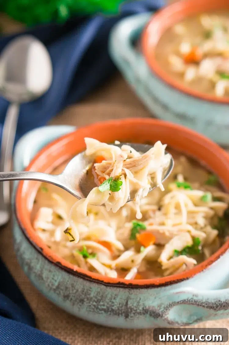Pressure Cooker Chicken Noodle Soup served in a white bowl.