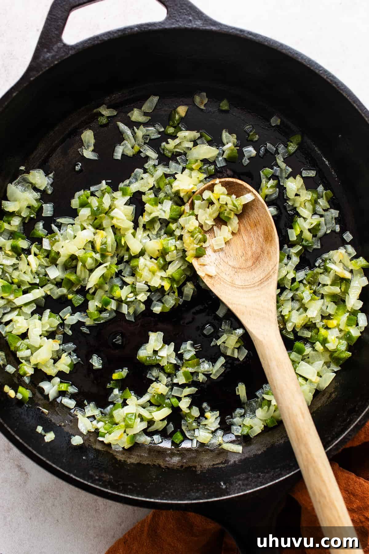 Elote Fiesta Dip 4 Finely diced onion and jalapeño sizzling in melted butter in a skillet, beginning to soften.