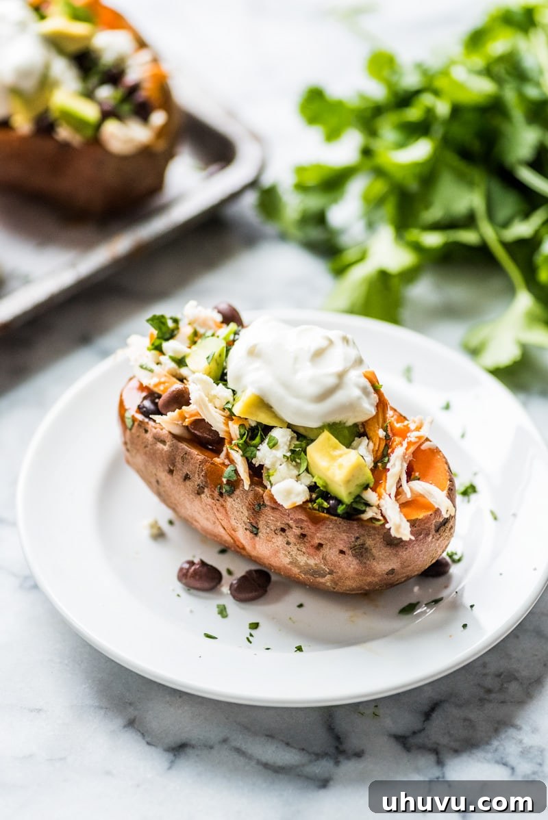 Enchilada Stuffed Sweet Potato Boats 6 The process of preparing a sweet potato, showing it halved and ready to be scooped and filled.