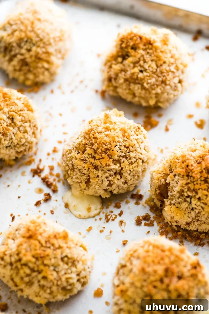 Zesty Fiesta Rice Bites 10 Freshly baked Mexican arancini rice balls, golden brown and crispy, indicating a healthier alternative to deep-frying.