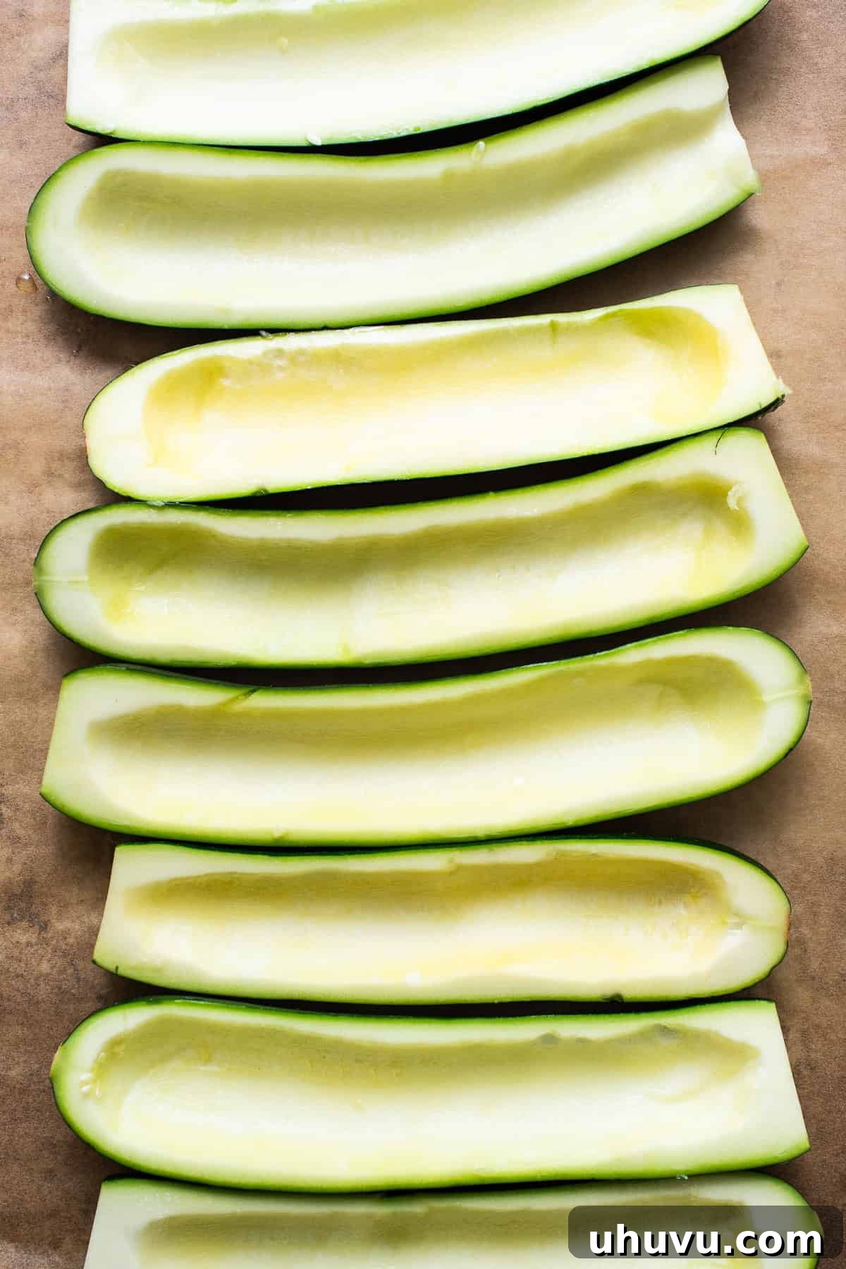 Savory Zucchini Delights 4 Zucchinis cut in half and seeds scooped out ready to use.