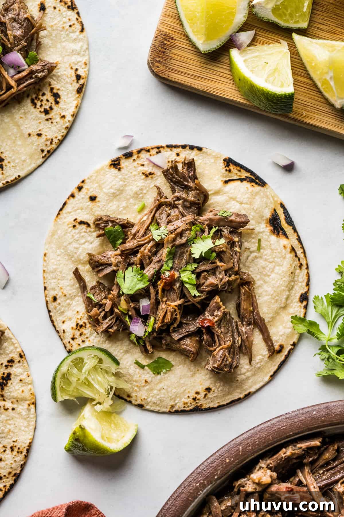 Melt-in-Your-Mouth Barbacoa 11 A warm corn tortilla generously filled with fully cooked barbacoa beef, topped with fresh cilantro and a lime wedge.