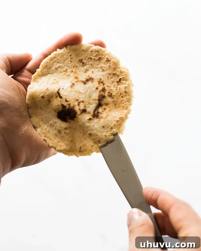 Homemade Gorditas: Authentic Mexican Stuffed Corn Cakes 9 Cutting open a gordita with a knife