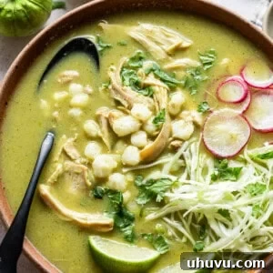 Pozole Verde, a hearty Mexican stew with chicken, hominy, and a green chile broth, garnished with cilantro.