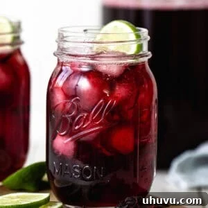 Agua de jamaica served in a glass with ice.