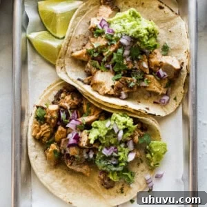Easy chicken tacos recipe made with tender and juicy diced chicken and topped with avocado, onions, and lime juice.