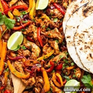 Sheet pan chicken fajitas with tortillas ready to eat.