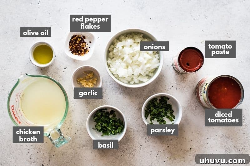 Quick Fiery Arrabbiata 3 Arrabiata sauce ingredients on a table including canned diced tomatoes and red pepper flakes.