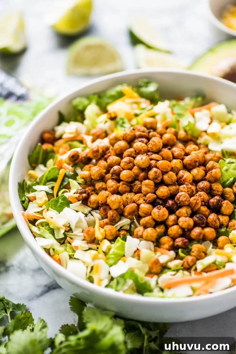 Chopped salad recipe topped with roasted chickpeas and avocado ranch dressing.